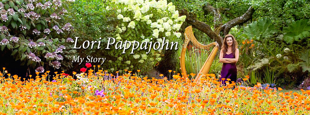 Lori Pappajohn and harp in field of orange flowers with tree.